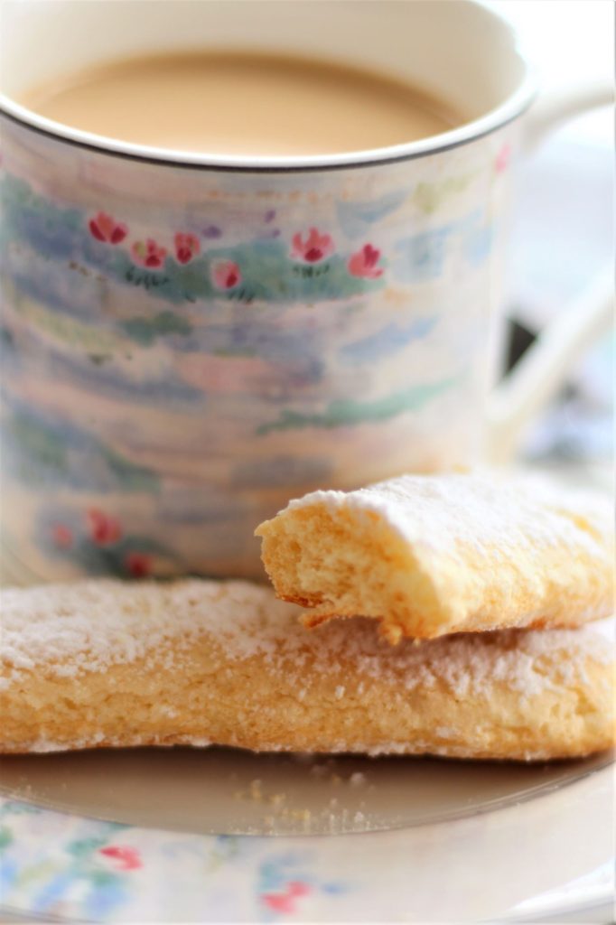 ladyfingers in front of coffee on saucer