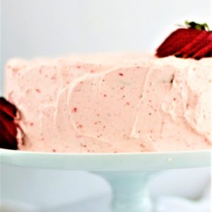 gluten free strawberry angel food cake on a white cake stand