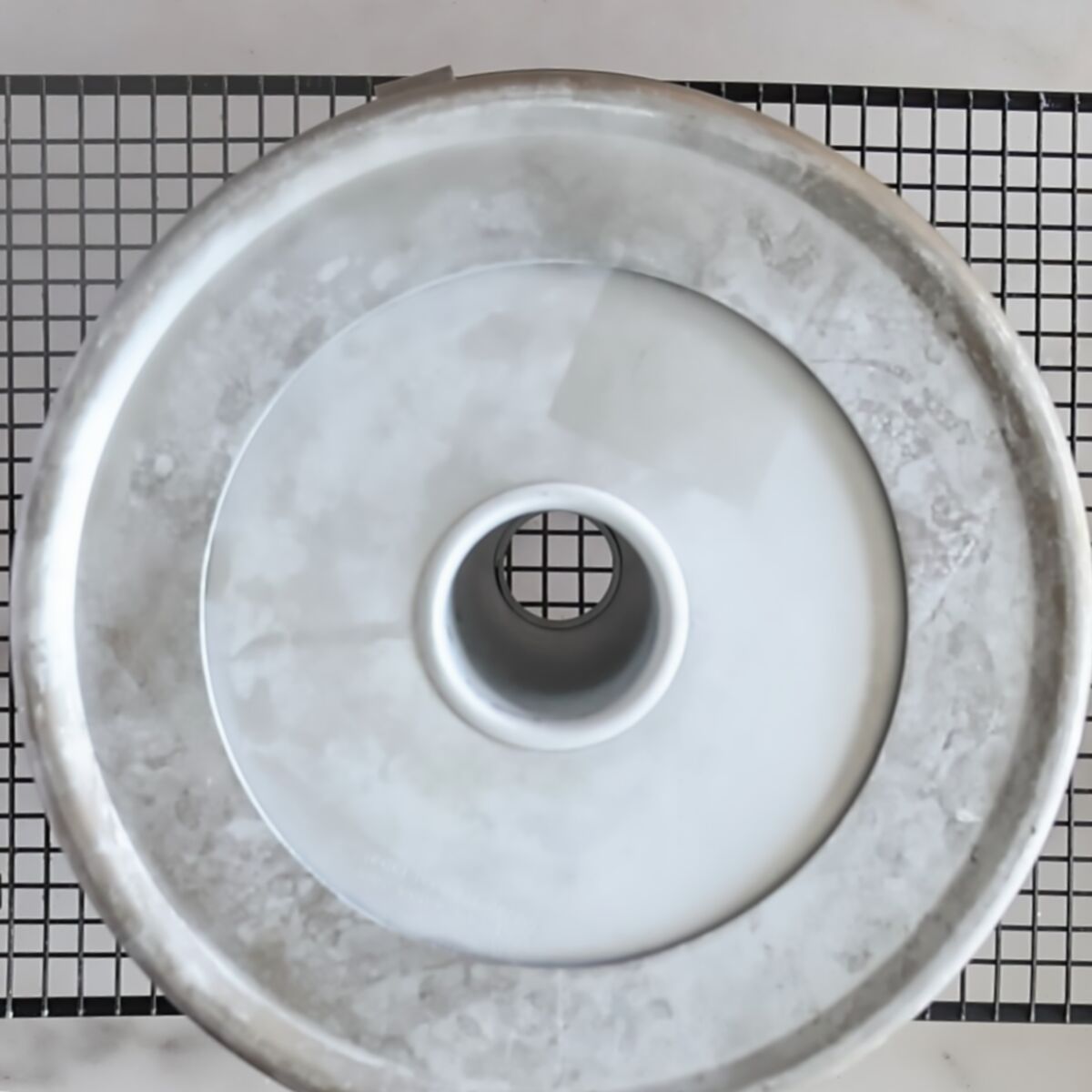 angel food pan upside down on cooling rack.