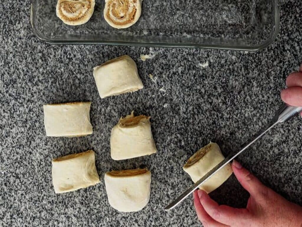 cutting semi-frozen logs of rolls in small pieces and placed in glass baking dish.
