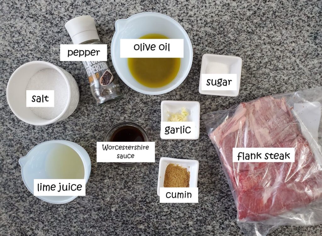 ingredients for flank steak marinade measured and labeled on granite countertop.