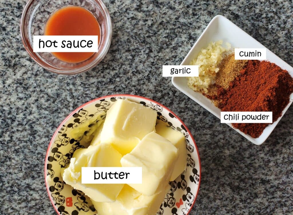 ingredients for chili butter measured out and labeled on granite countertop.