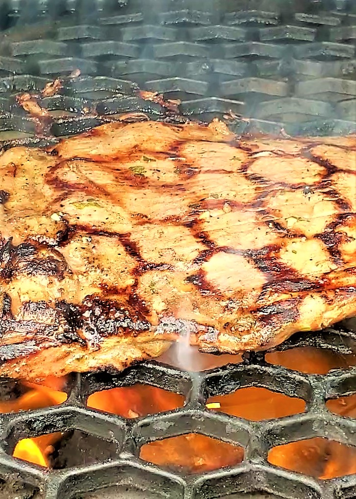 searing flank steak on a hot grill