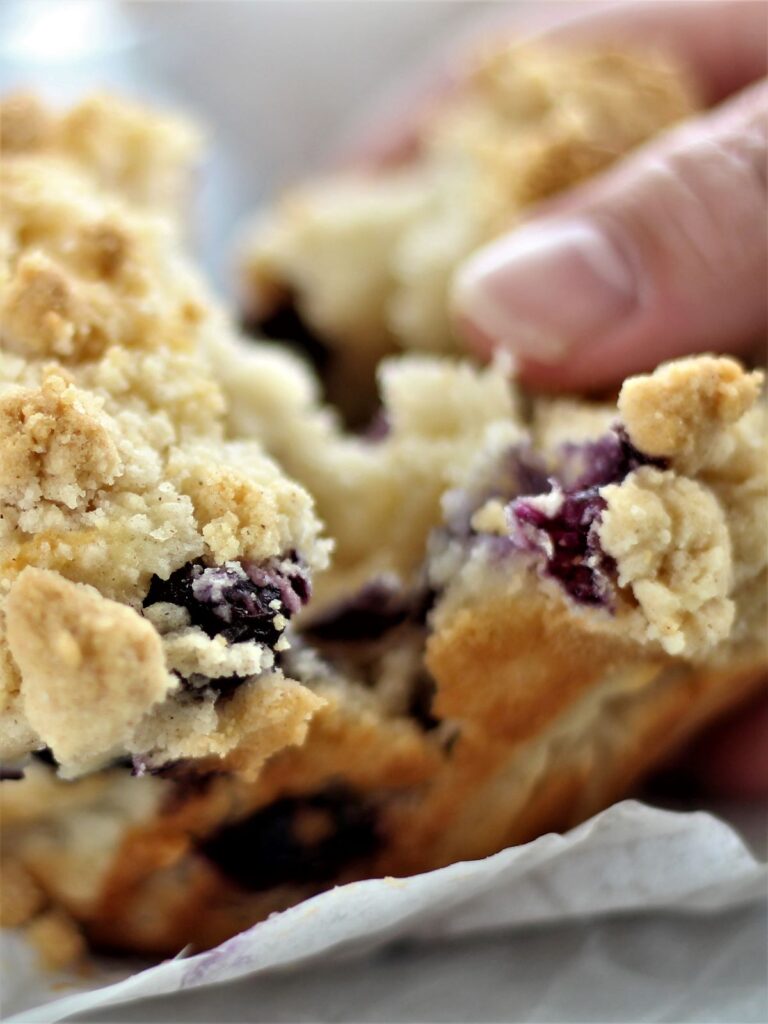 breaking open jumbo blueberry muffin