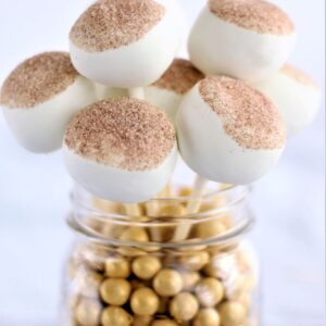 jar filled with gold round candies and gf cinnamon cake pops
