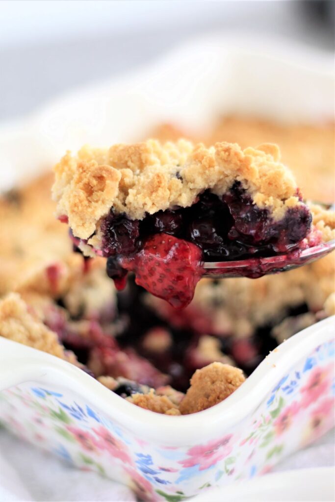 large spoonful of fruit crumble 