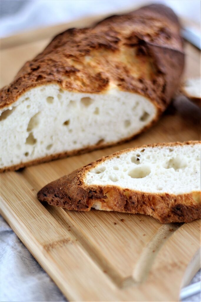 gluten free italian bread on cutting board with slice 