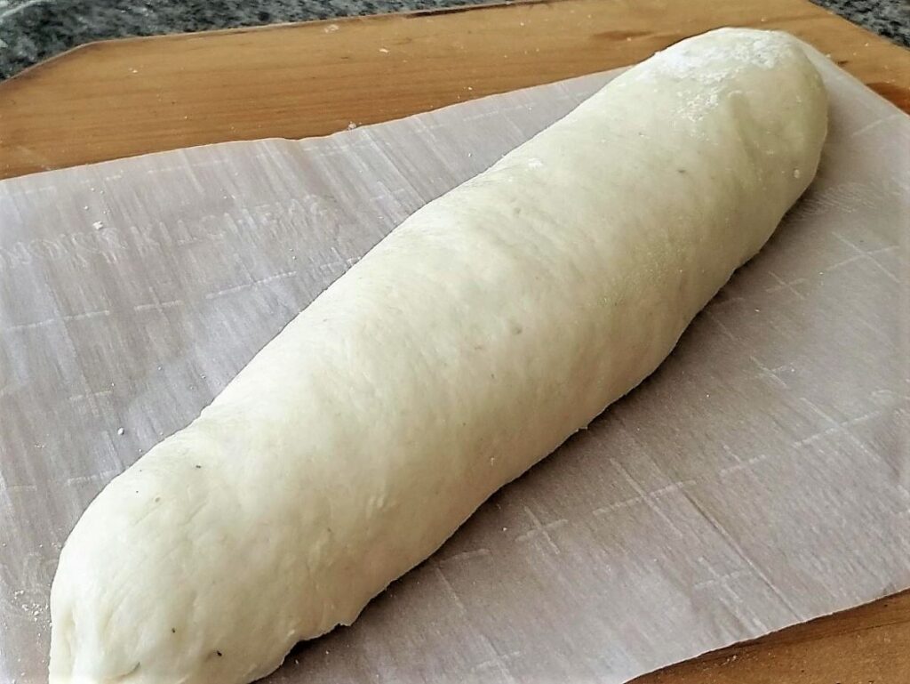 shaped loaf of dough on parchment paper