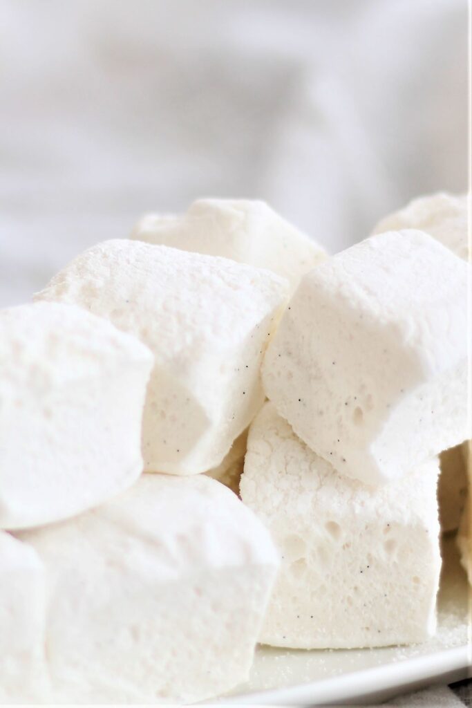 white plate stacked with homemade marshmallows