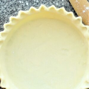 gluten free pie crust on granite top with wooden french rolling pin