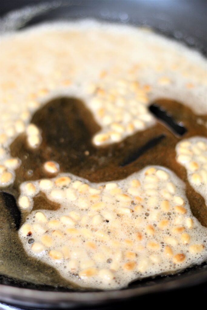 pine nuts being sauteed in brown butter