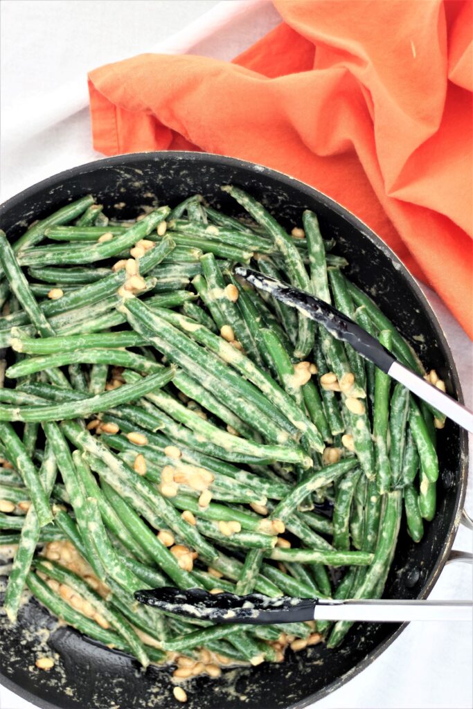 green beans in saute pan with orange napkin on the side