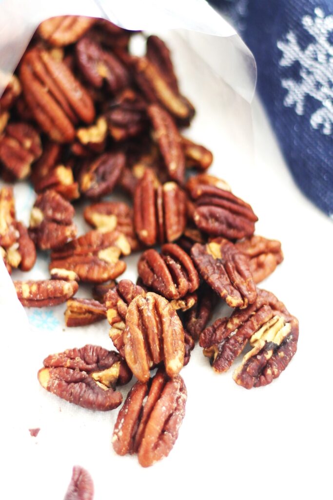 pecans spilled out from cellophane bag onto white towel