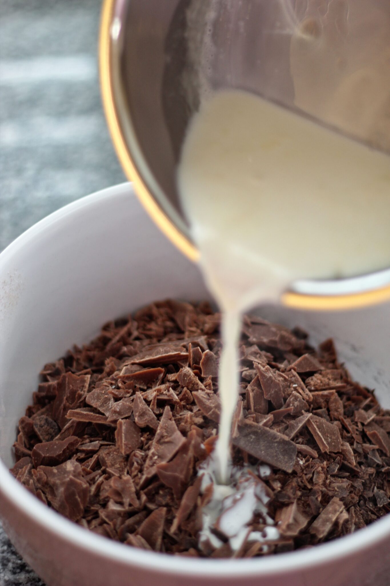 pouring hot heavy cream over chopped chocolate for ganache