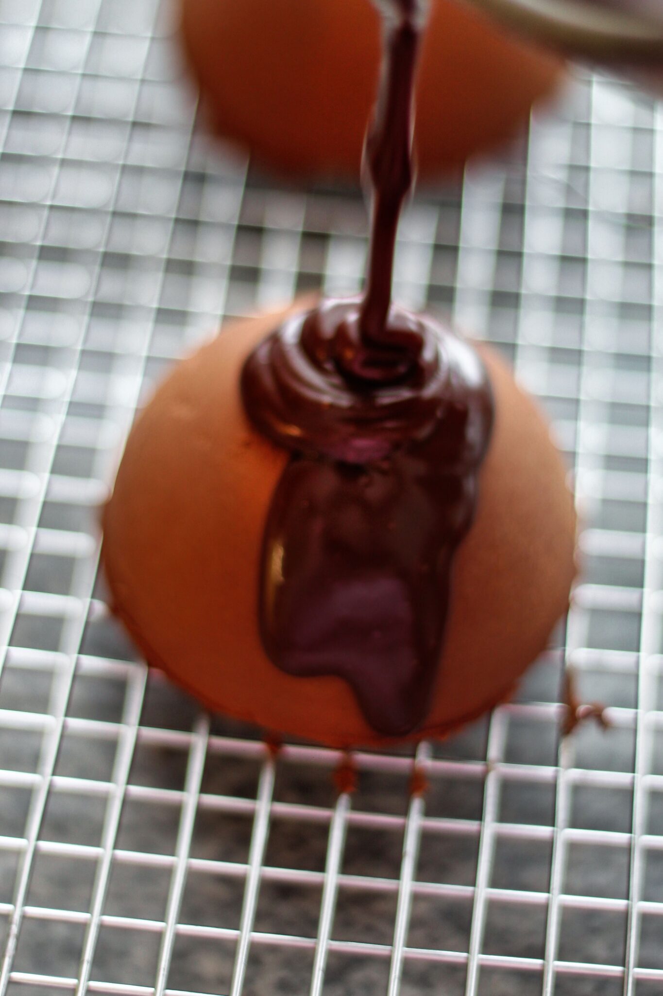 pouring ganache over mousse cakes