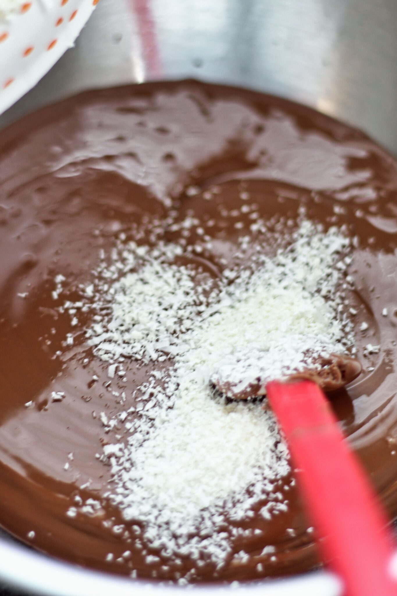 adding grated cocoa butter to melted chocolate