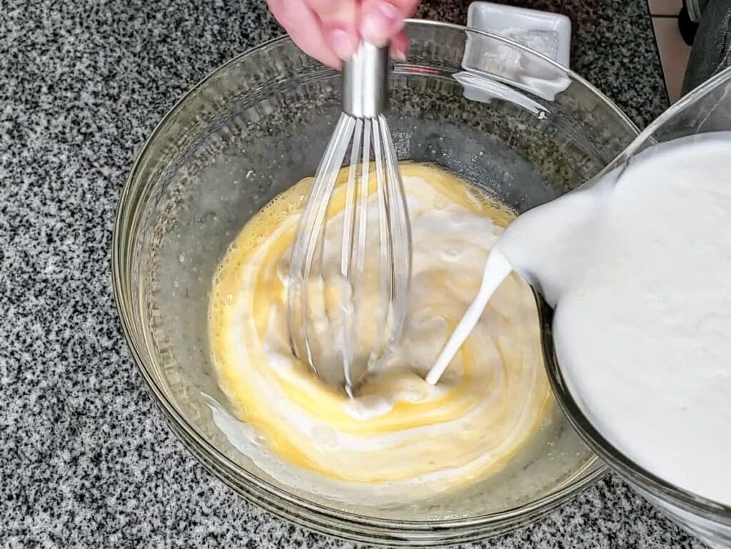 adding buttermilk to eggs and sugar.