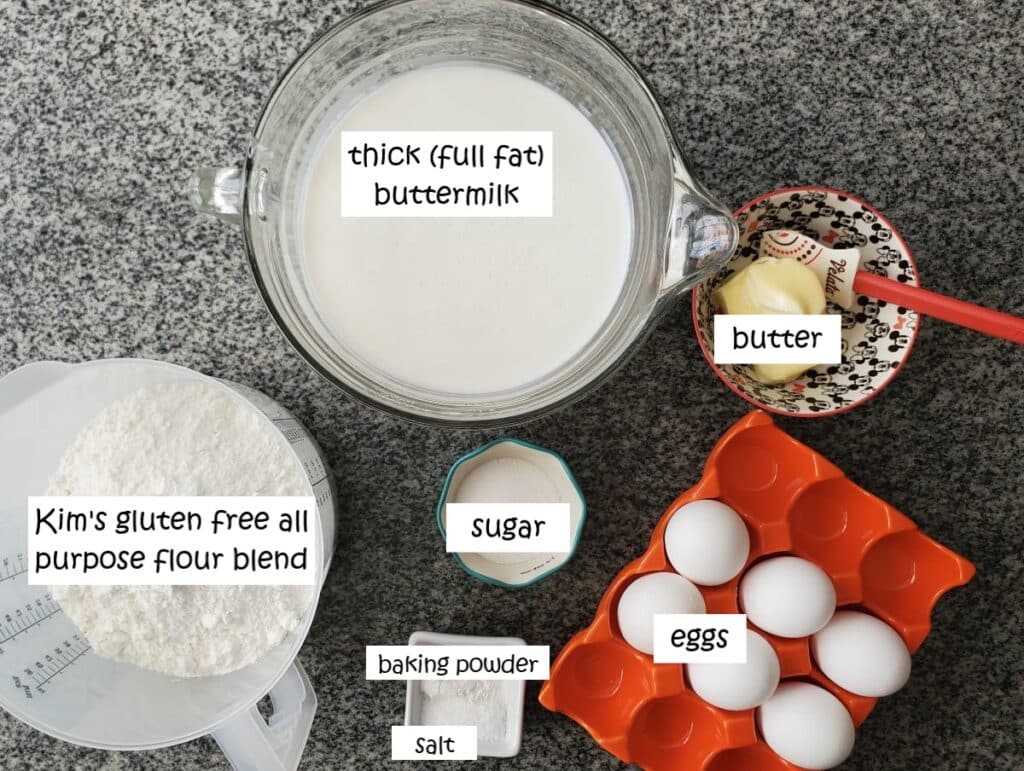 ingredients for pancakes measured out and labeled on granite countertop.