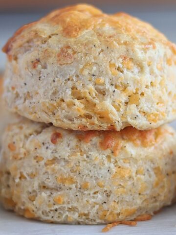two cheese scones stacked one on top of the other.
