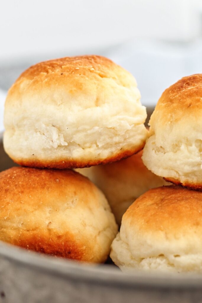 pillowy soft gluten free dinner rolls stacked on top of each other