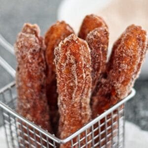 gluten free churros in basket with dipping sauces