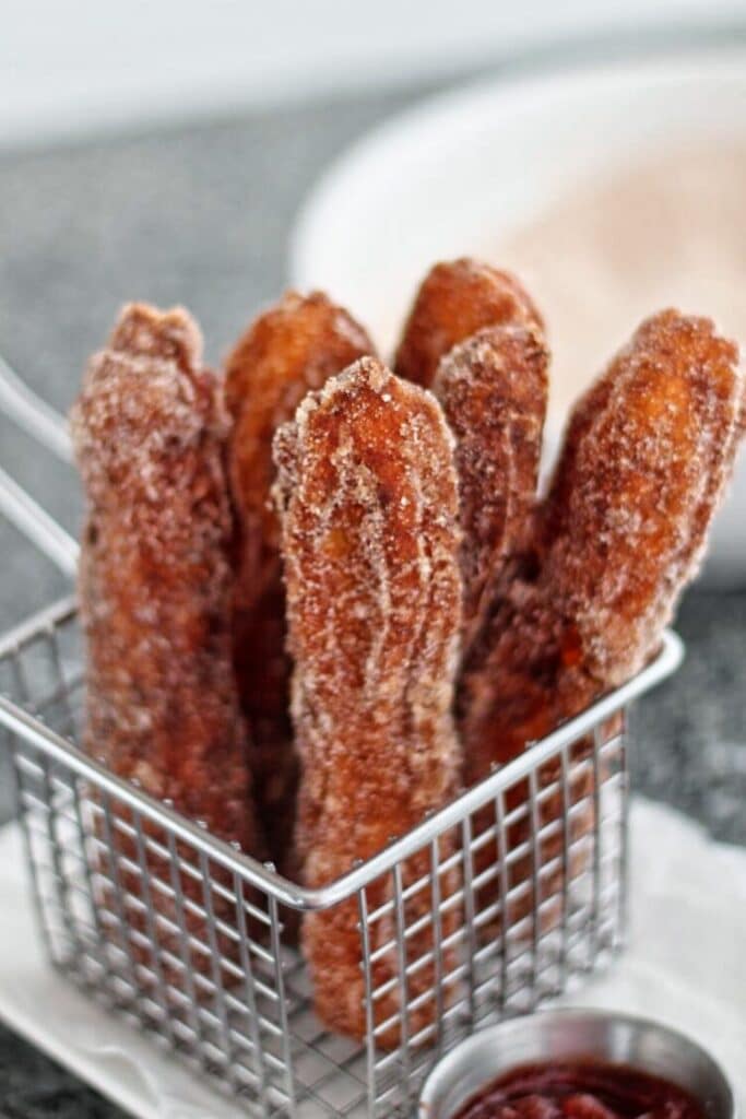 gluten free churros in basket with dipping sauces