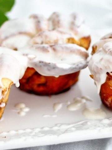 landscape view of large cinnamon knots on rectangular white platter