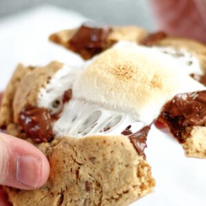 pulling apart smores cookie with melted marshmallow