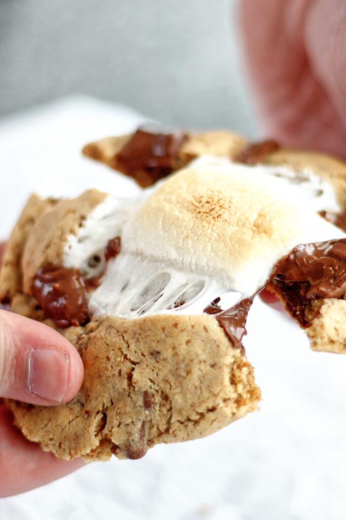 pulling apart smores cookie with melted marshmallow