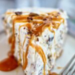 gluten free frozen candy bar pie slice with caramel sauce drizzled on top