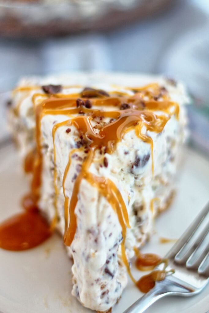 gluten free frozen candy bar pie slice with caramel sauce drizzled on top