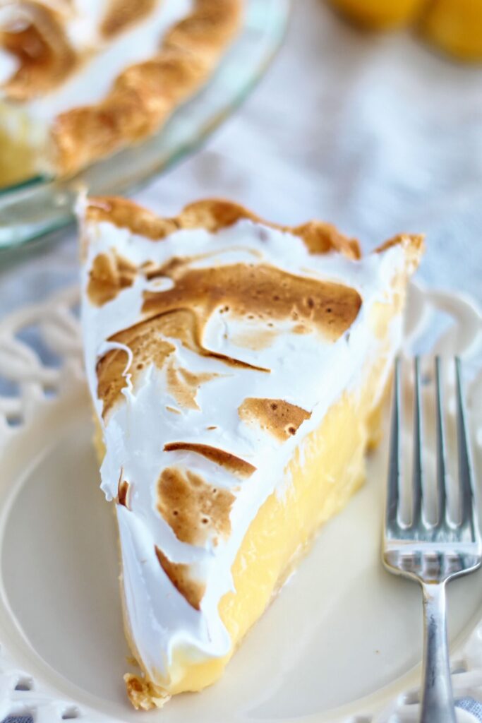 slice of gf lemon meringue pie on white plate