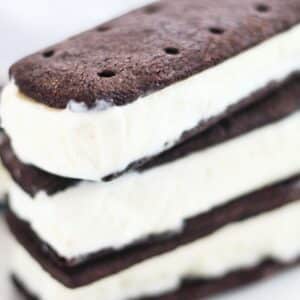 three ice cream sandwiches stacked on a white plate