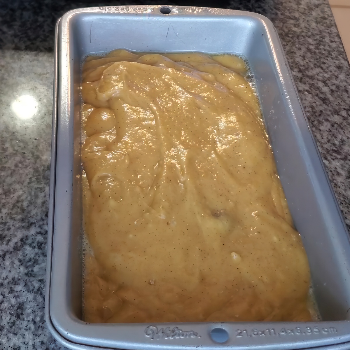 pumpkin bread batter in loaf pan.