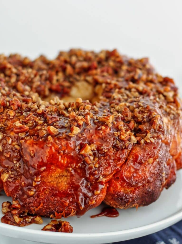 up close view of whole monkey bread on white cake stand.