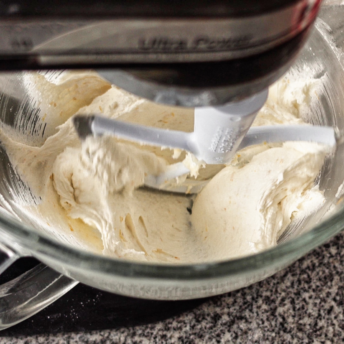 creaming butter and cream cheese with sugar and lemon zest in stand mixer bowl.