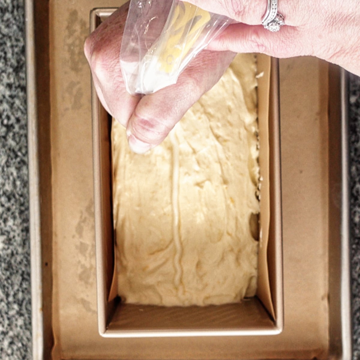 piping softened butter in a line down middle of batter in loaf pan.