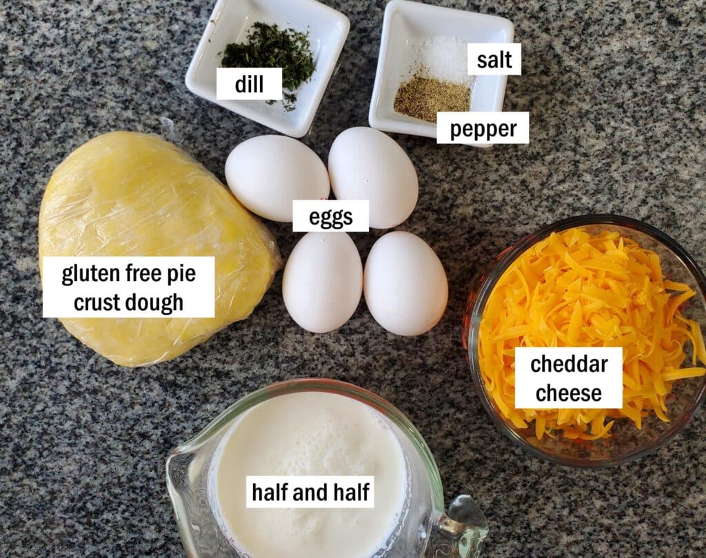 ingredients for cheddar dill tartlets measured out and labeled on granite countertop.