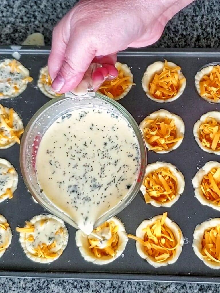 pouring filling into gf tartlets.