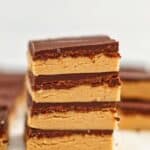 four stacked no bake peanut butter bars up close.