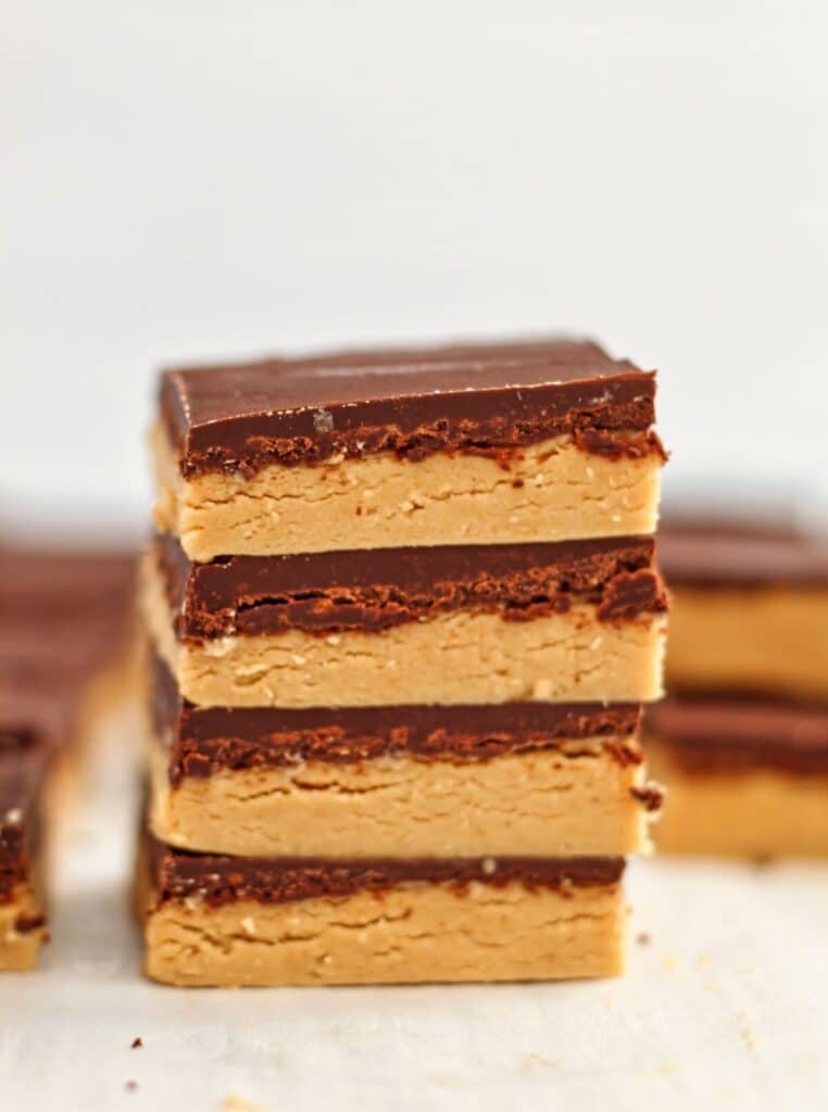 four stacked no bake peanut butter bars up close.
