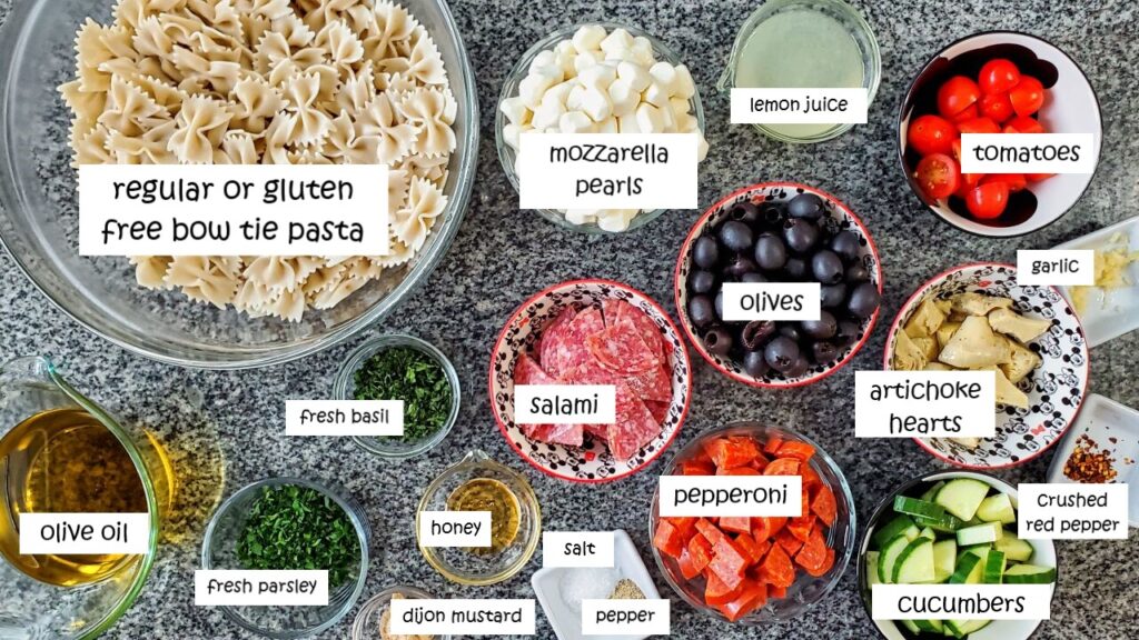 ingredients needed to make gf italian pasta salad measured out and labeled.