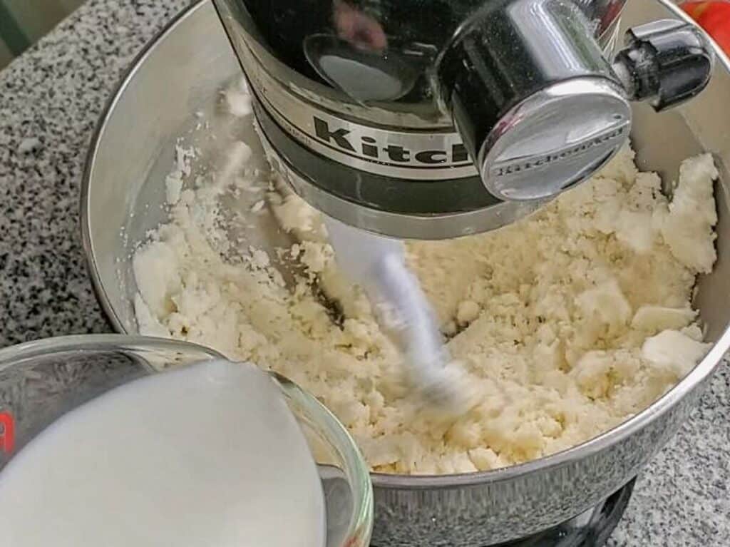 pouring milk into other batter ingredients.