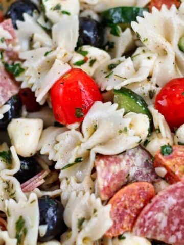 landscape view of italian bow tie pasta salad in big white bowl.