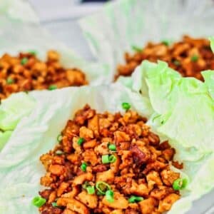 chicken or tofu lettuce wraps on white plate.