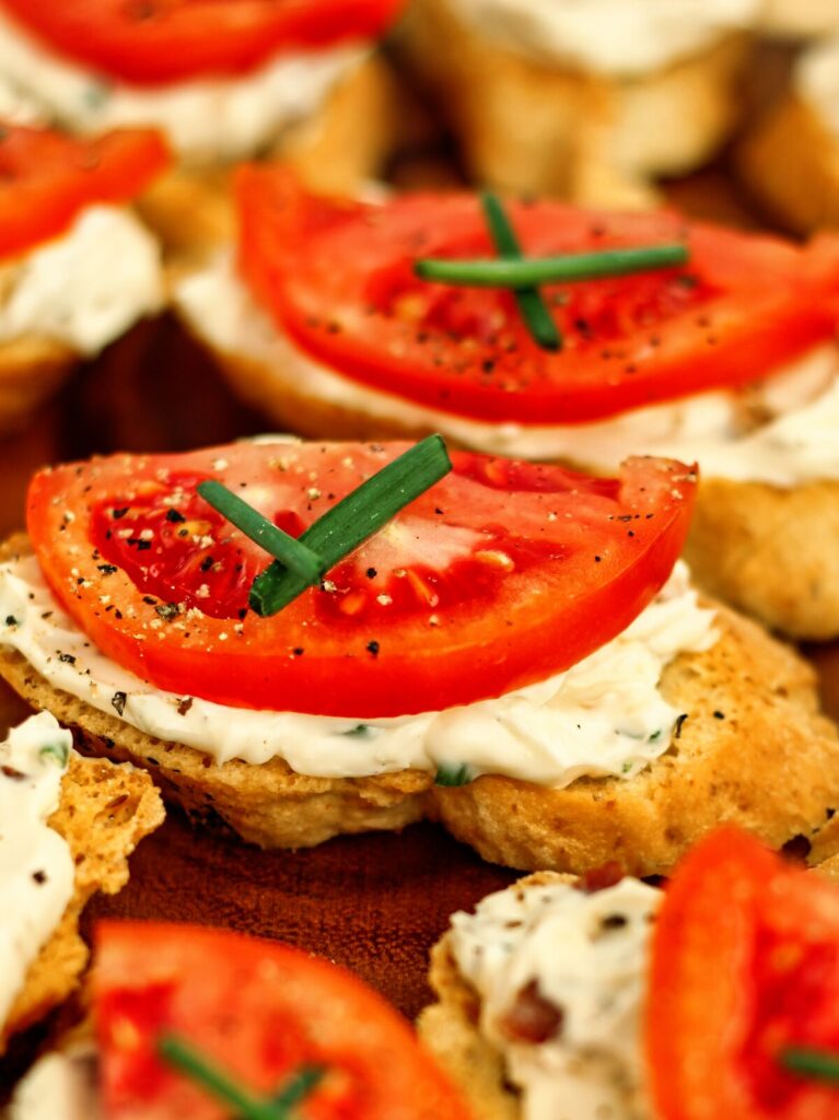 gluten free tomato crostini with chive cross on top.  