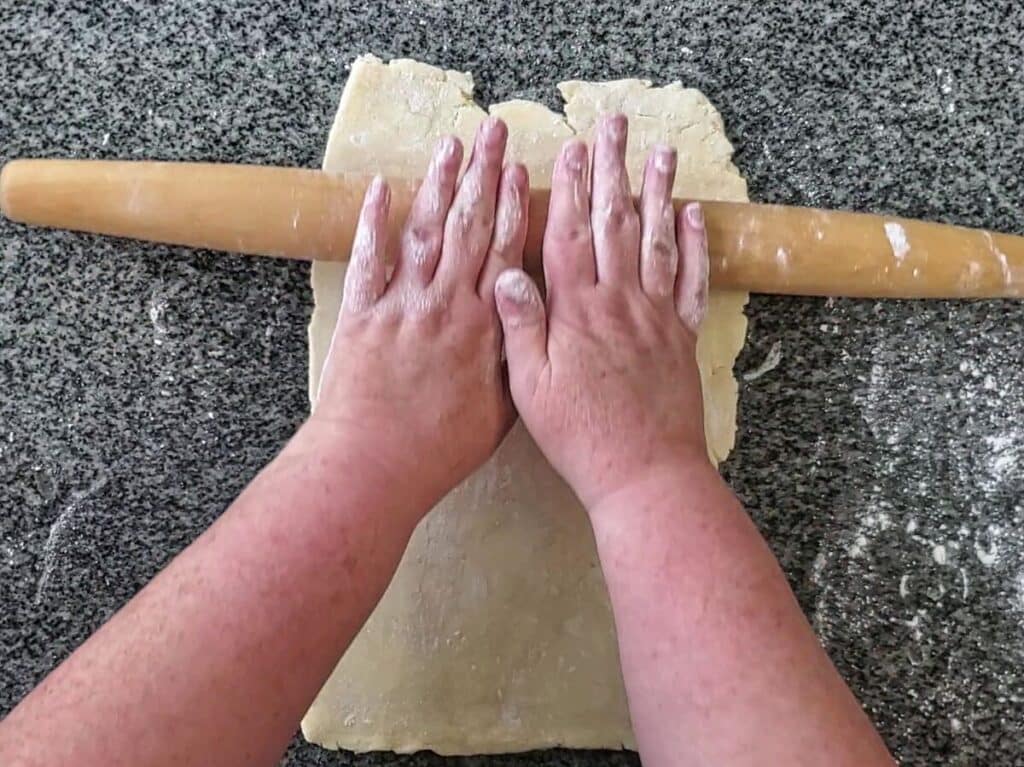 rolling out dough into a rectangle.