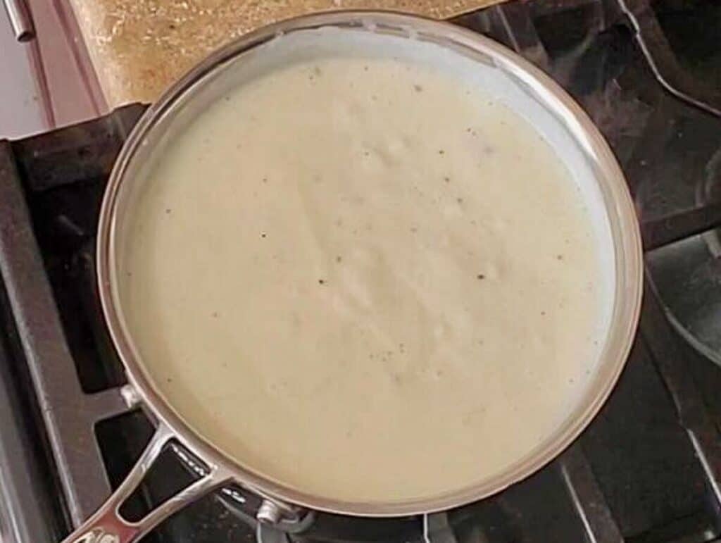 finished thickened bechamel in saucepan.