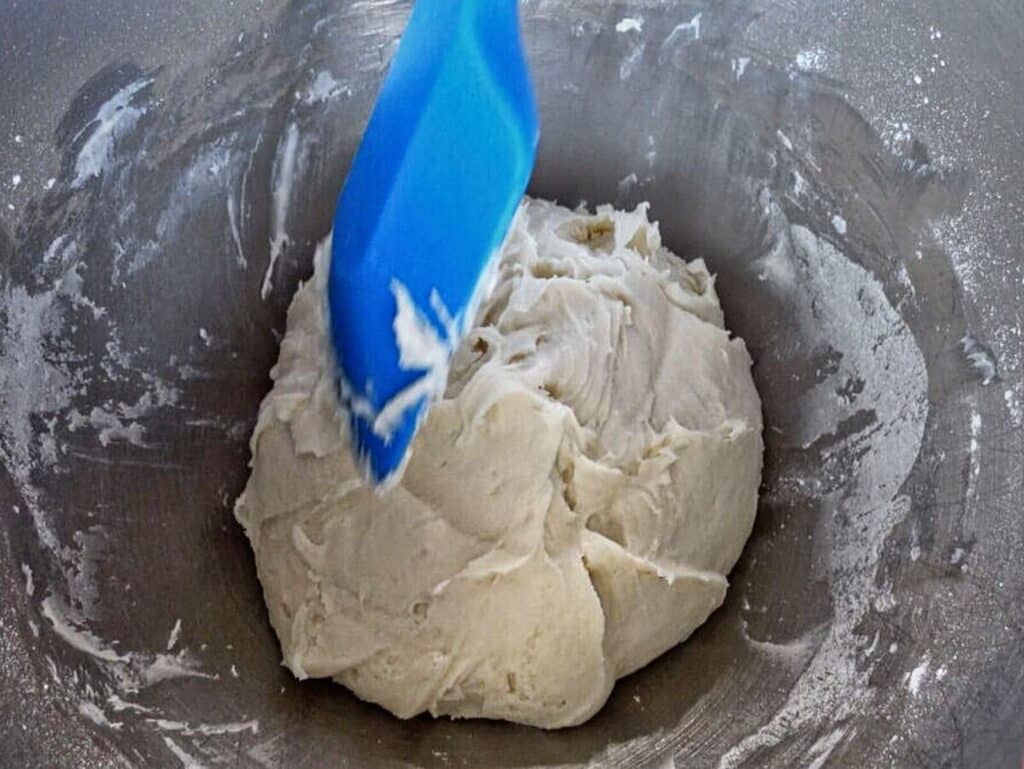 dough scraped into middle of mixing bowl.