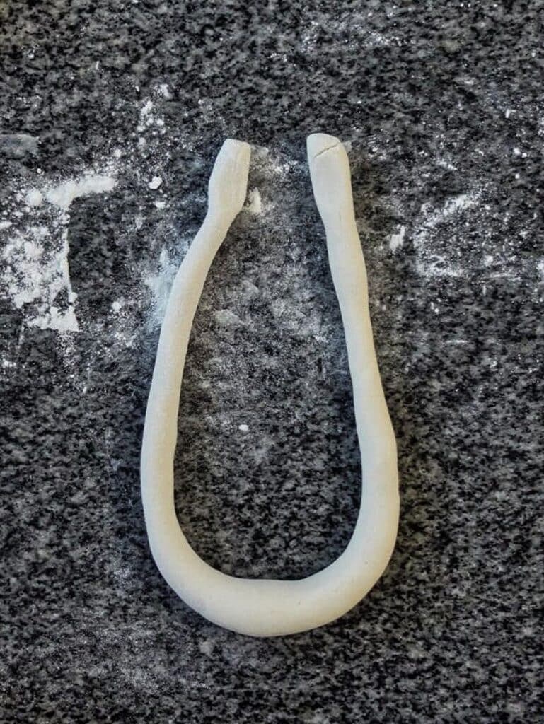 rope of pretzel dough shaped into a large U